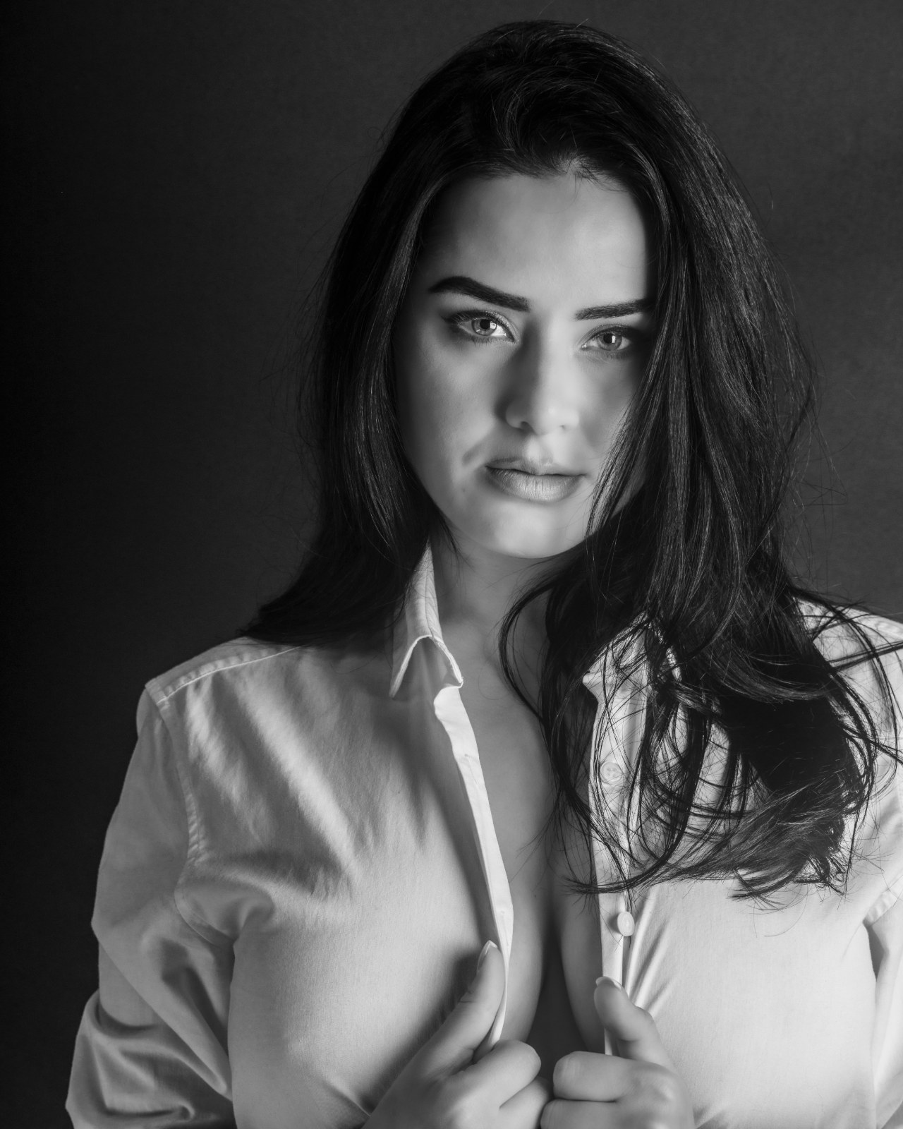 Black-and-white portrait of a woman in an open white shirt, from Beauty — Studio Studies I by Jonathan B. Landman.