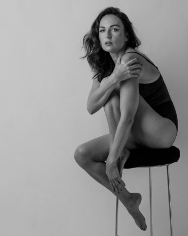Black-and-white seated studio portrait of a woman posed in shadow and light, from Beauty — Studio Studies I by Jonathan B. Landman.
